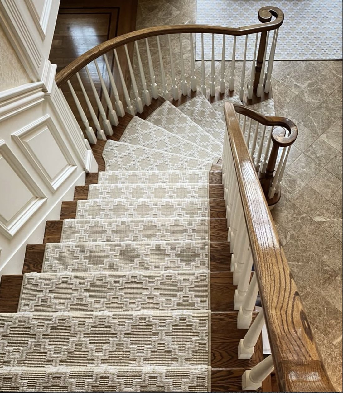 Custom patterned stair runner on a curved Hamptons staircase