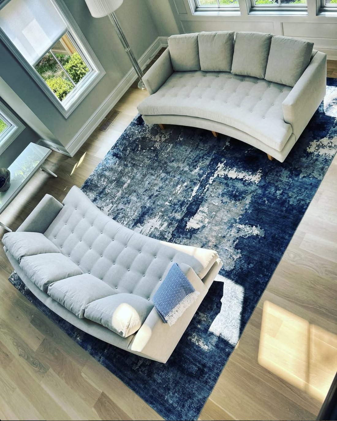 Living room with deep blue area rug